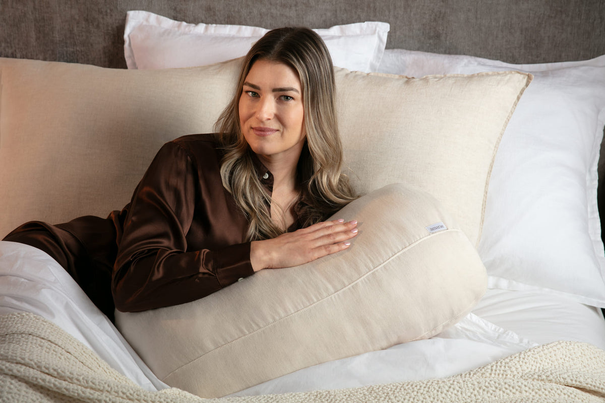 Sculptural Amarae pillow styled in a warm, minimalist interior